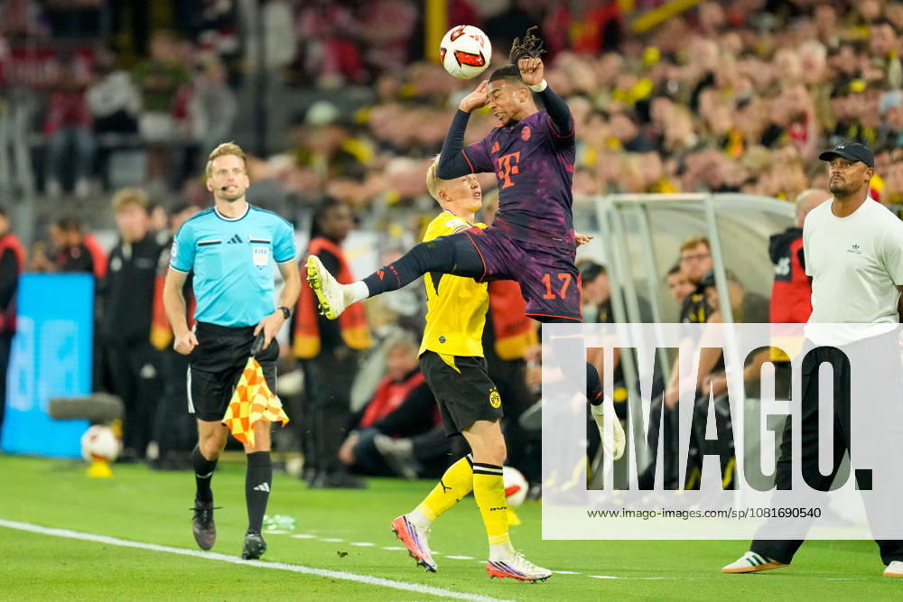 Daniel Svensson of Borussia Dortmund and Michael Olise of FC Bayern Munich battle for the ball during the Franz Beckenbauer Super Cup match between Borussia Dortmund and FC Bayern Munich at Signal Iduna Park on August 22, 2026, in Dortmund, Germany. Photo by Alex Gottschalk, DeFodi Images