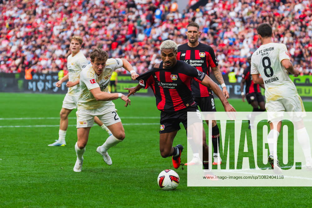 Tim Skarke of 1. FC Union Berlin (No. 21) battles Loic Bade of Bayer 04 Leverkusen (No. 05) for the ball in the penalty area; they’re pulling on each other’s jerseys, Robert Andrich of Bayer 04 Leverkusen, No. 08, watches; Bayer 04 Leverkusen vs. 1 FC Union Berlin, soccer, Bundesliga 1, Matchday 2, 2026–27 season, May 9, 2026, DFL regulations prohibit any use of photographs as image sequences and or quasi-video, Bayer 04 Leverkusen vs. 1 FC Union Berlin, soccer, Bundesliga 1, Matchday 2, 2026–27 season, May 9, 2026, Leverkusen