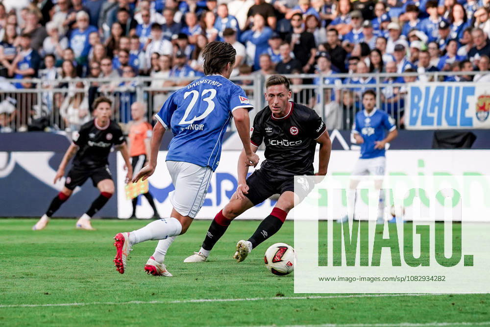 Germany Soccer Season 2026–2027, 2. Bundesliga, Matchday 5, SV Darmstadt 98 vs. Arminia Bielefeld, Merck Stadium at Böllenfalltor, Darmstadt. Carlo Sickinger of SV Darmstadt 98, No. 23, on the ball, in possession, in a tackle with Marius Wörl of Arminia Bielefeld, 38 Darmstadt, Merck Stadium at Böllenfalltor, Germany
