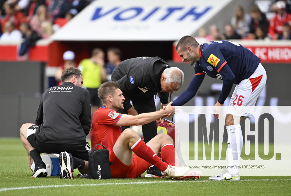 Patrick Mainka 1 FC Heidenheim 1846 FCH 06 is injured; lying on the ground; David Zec of Holstein Kiel 26 helps him to his feet; gesture; 1 FC Heidenheim 1846 FCH vs. Holstein Kiel KSV September 13, 2026; DFL REGREGULATIONS PROHIBIT ANY USE OF PHOTOGRAPHS AS IMAGE SEQUENCES AND OR QUASI-VIDEO 1 FC Heidenheim 1846 FCH vs. Holstein Kiel KSV