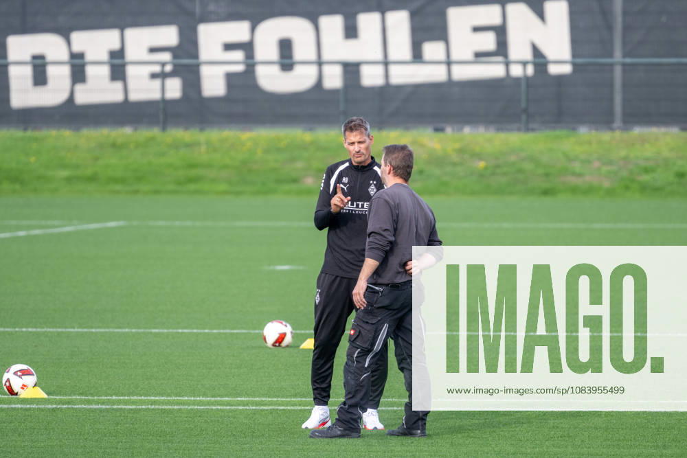 Alexander Blessin of Borussia Mönchengladbach, coach, talking with a groundskeeper before practice. Borussia Mönchengladbach open practice, soccer, Bundesliga, 2026–2027 season, September 29, 2026, Borussia Mönchengladbach open training session, soccer, Bundesliga, 2026–2027 season, September 29, 2026, Mönchengladbach