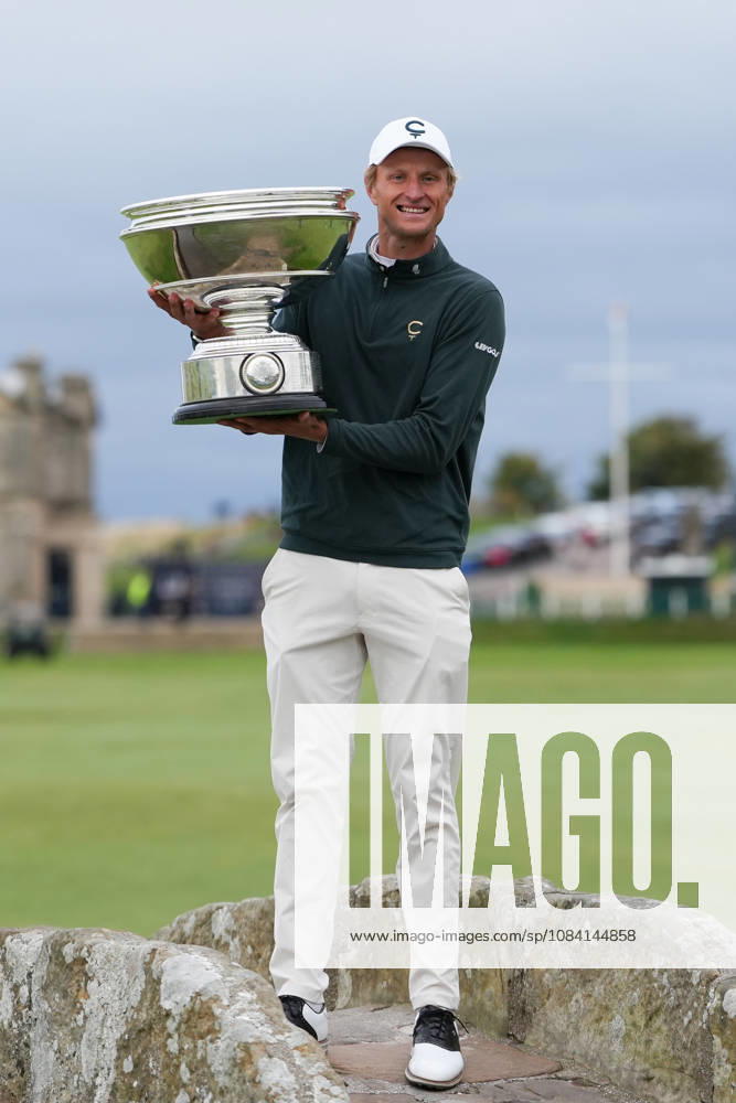 4th October 2026; Old Course at St Andrews, St Andrews Scotland; DP World Tour Golf, Alfred Dunhill Links Championship, Final Day; Adrian Meronk lifts the Alfred Dunhill trophy on the Swilcan Bridge after winning the tournament and becoming champion golfer AlecxBrown