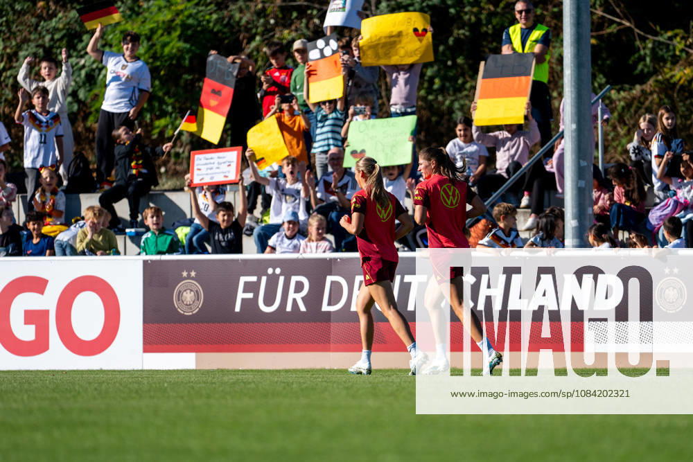 GER, Soccer, Women, Practice, DFB German National Team: Marie Müller (Germany), Melissa Kössler (Germany); in the background, fans—schoolchildren from the Baden Soccer Association—in the stands with flags and posters; Heidelberg ASV Eppelheim, Baden-Württemberg, Germany