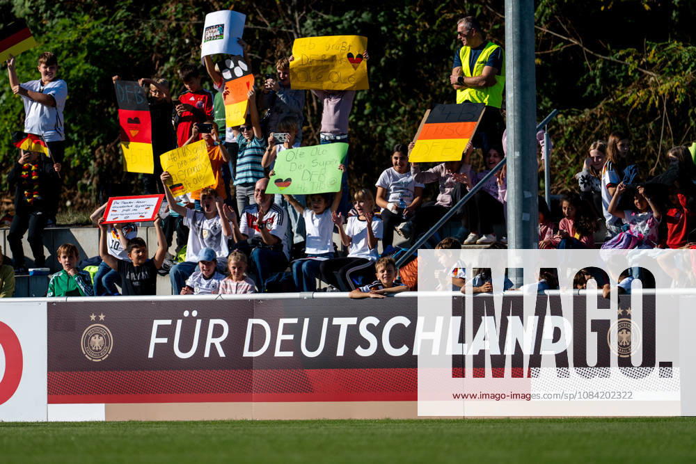 GER, Soccer, Women, Practice, DFB German National Team: Marie Müller (Germany), Melissa Kössler (Germany); in the background, fans—schoolchildren from the Baden Soccer Association—in the stands with flags and posters; Heidelberg ASV Eppelheim, Baden-Württemberg, Germany