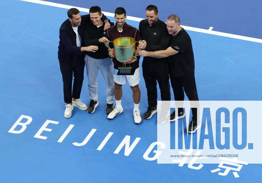 (261006) -- BEIJING, Oct. 6, 2026 -- Winner Novak Djokovic of Serbia pose for photos with his team staff after the awarding ceremony for the men s singles final at 2026 China Open tennis tournament in Beijing, China, Oct. 6, 2026. ) (SP)CHINA-BEIJING-TENNIS-CHINA OPEN-MEN S SINGLES-AWARDING CEREMONY(CN) ZhangxChenlin