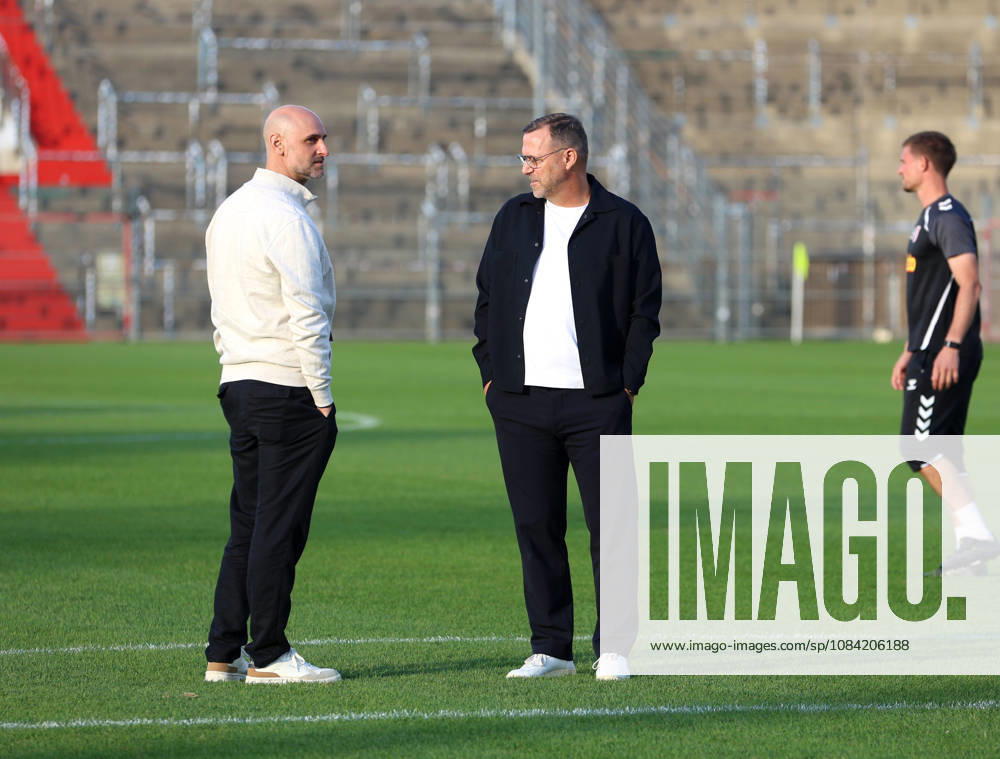 Soccer, Men s, Toto Cup, Quarterfinals, 2026–2027 Season, SpVgg Unterhaching vs. SSV Jahn Regensburg, Sportpark Unterhaching: Dr. Alexander Schmalhofer, sporting director of SSV Jahn Regensburg (left), and Sascha Hildmann, head coach of SSV Jahn Regensburg (right), standing on the field in conversation