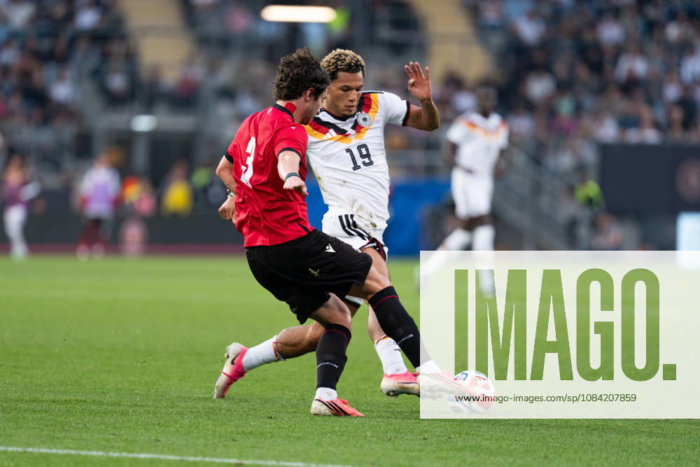 GER, Germany U21 vs. Georgia U21: A duel between Paris Brunner (Germany U21, 19) and Dato Bukia (Georgia U21, 3) at the SchücoArena in Bielefeld, Germany