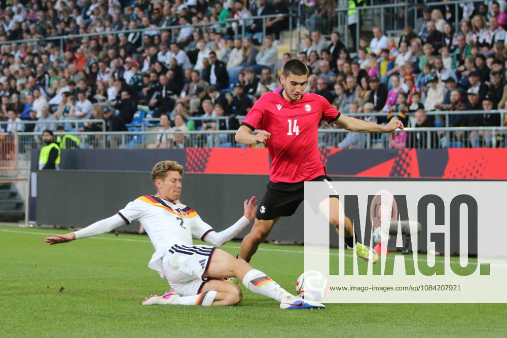 Men s Soccer 2026–2027 UEFA U-21 European Championship Qualifiers Matchday 12 Germany vs. Georgia SchücoArena, Bielefeld Elias Baum (Germany, No. 2, in white) slides in to tackle Aleko Basiladze (Georgia, 14, red card from Bielefeld, North Rhine-Westphalia, Germany