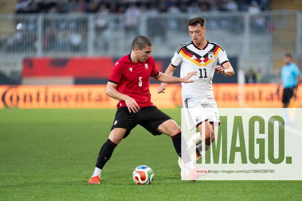 GER, Germany U21 vs. Georgia U21: A duel between Dzenan Pejcinovic (Germany U21, No. 11) and Aleksandre Amisulashvili (Georgia U21, No. 5) at the SchücoArena in Bielefeld, Germany