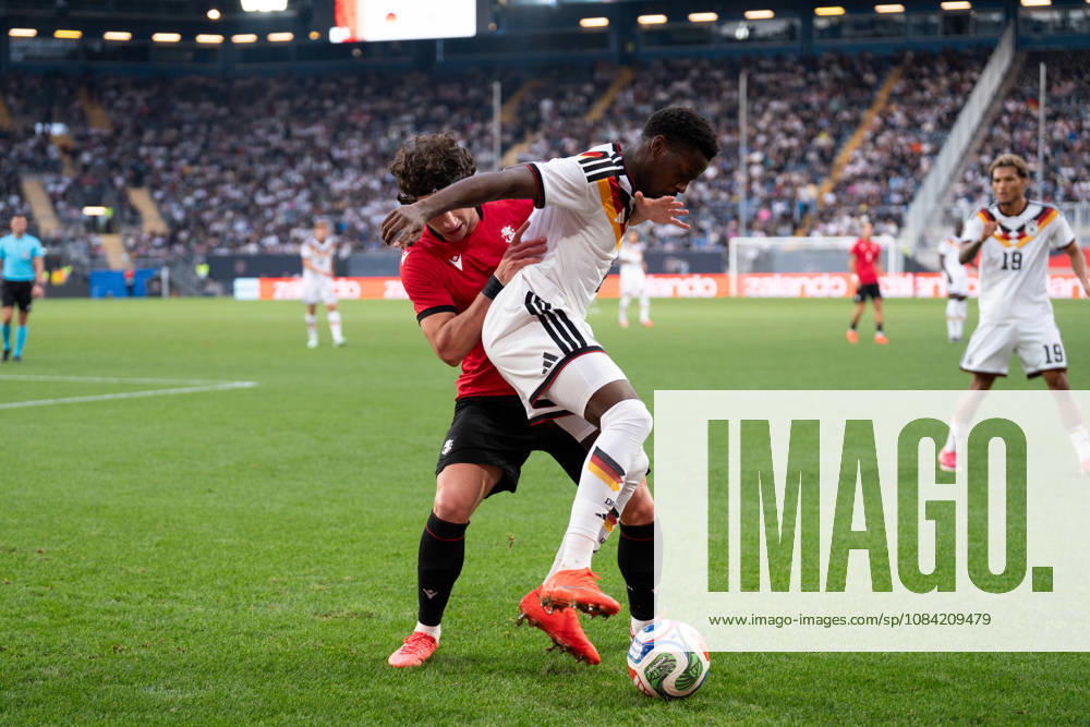 GER, Germany U21 vs. Georgia U21: A duel between Noel Aseko (Germany U21, No. 8) and Dato Bukia (Georgia U21, No. 3) at the SchücoArena in Bielefeld, Germany