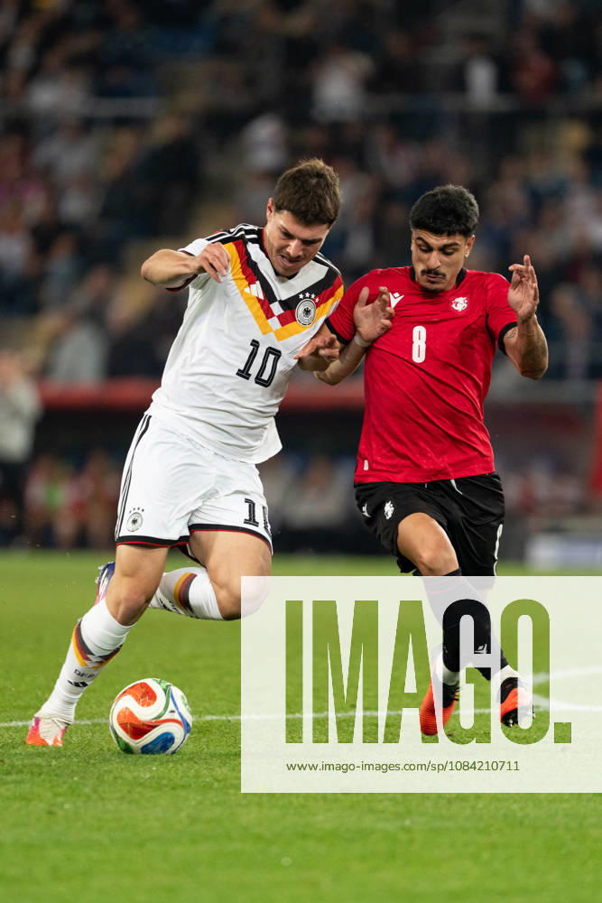 GER, Germany U21 vs. Georgia U21: A duel between Mert Kömür (Germany U21, No. 10) and Giorgi Robakidze (Georgia U21, No. 8) at the SchücoArena in Bielefeld, Germany