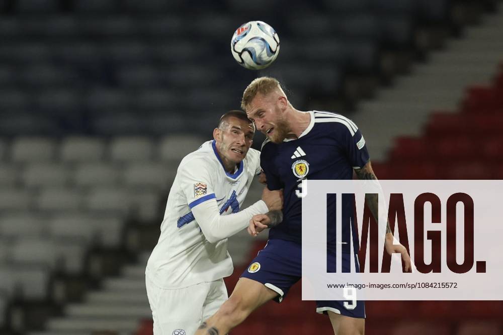 6th October 2026; Hampden Park, Glasgow, Scotland; UEFA Nations League Football, Scotland versus Slovenia; Oli McBurnie of Scotland competes in the air with David Zec of Slovenia DavidxYoung