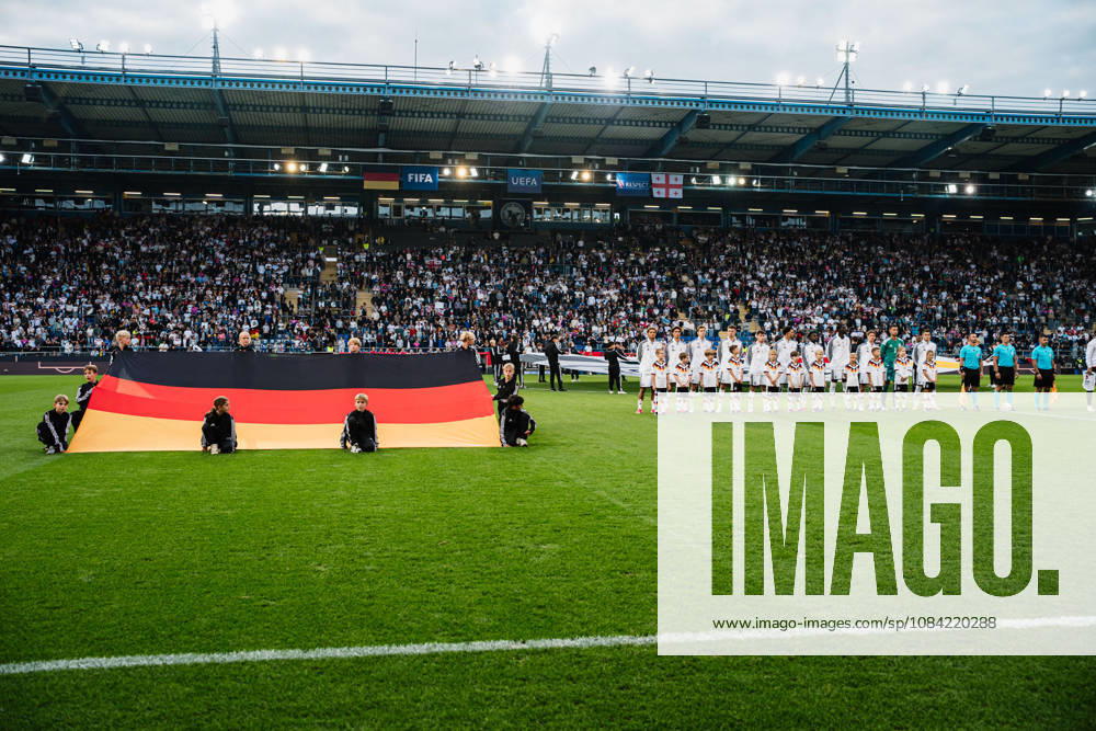 U21 European Championship Qualifier: Germany vs. Georgia, October 6, 2026; Germany during the national anthem: Paris Brunner (Germany), 19; Noah Darvich (Germany), 17; Aljoscha Kemlein (Germany), 16; Dženan Pejcinovic, Germany, 11, Nnamdi Collins, Germany, 20, Noel Aseko, Germany, 8, Joshua Quarshie, Germany, 5, Lukas Ullrich, Germany, 3, Elias Baum, Germany, 2, Mio Backhaus, Germany, 1, Nicolò Tresoldi Germany, 9, next to it: Germany on the ground playing soccer, U-21 European Championship Qualifiers, Matchday 10: Germany vs. Georgia on October 6, 2026, Bielefeld DFB REGULATIONS PROHIBIT ANY USE OF PHOTOGRAPHS AS IMAGE SEQUENCES AND OR QUASI-VIDEO