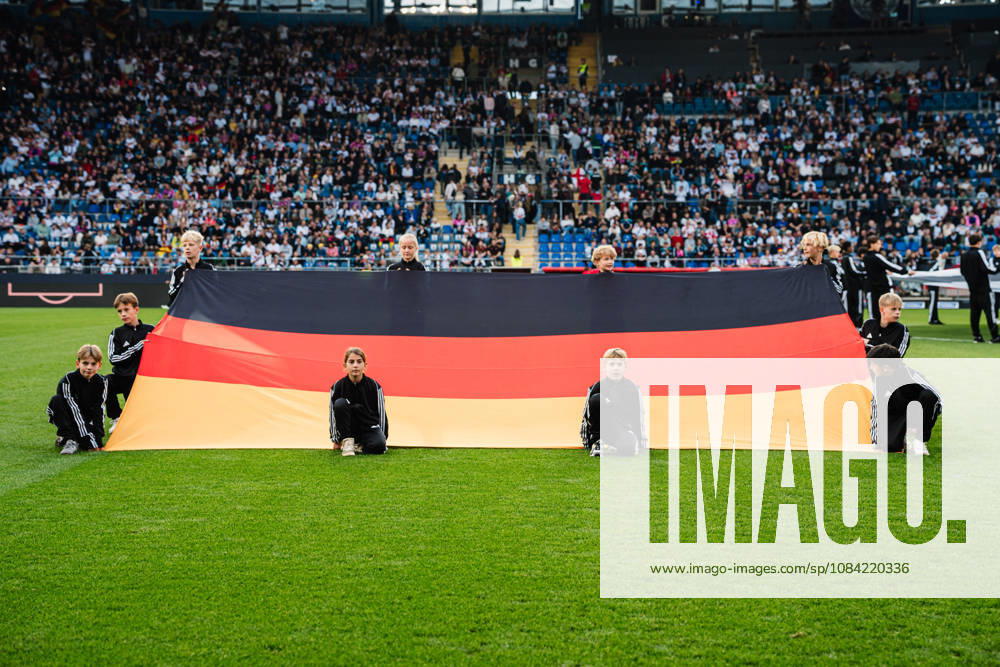 U-21 European Championship Qualifier: Germany vs. Georgia, October 6, 2026—German flag on the ground, held by children; soccer, U-21 European Championship Qualifier, Matchday 10: Germany vs. Georgia on October 6, 2026, Bielefeld DFB REGULATIONS PROHIBIT ANY USE OF PHOTOGRAPHS AS IMAGE SEQUENCES AND OR QUASI-VIDEO