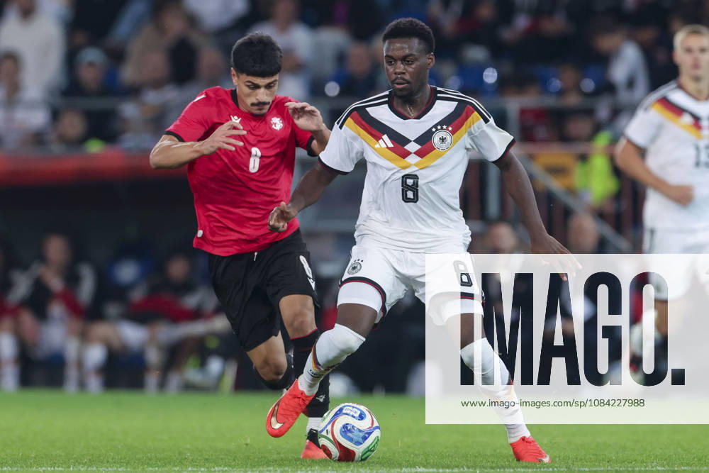 Dachi Lordkipanidze of Georgia and Noel Aseko of Germany battle for the ball during the UEFA Under-21 EURO qualifier between Germany U21 and Georgia U21 at Almstadion on October 6, 2026, in Bielefeld, Germany. Photo by Marco Steinbrenner, DeFodi Images