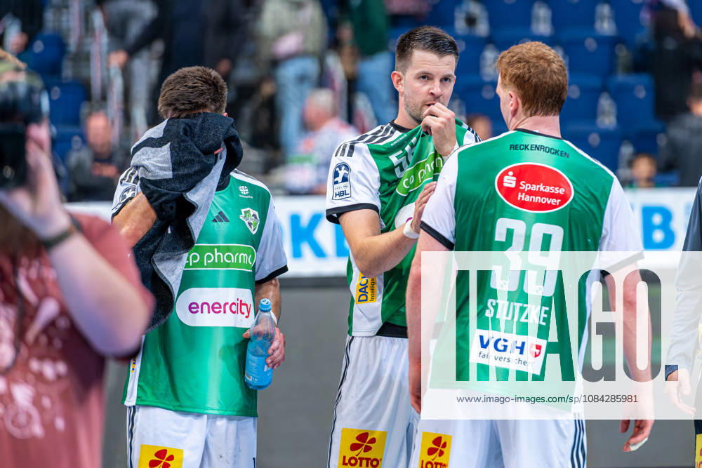 Renars Uscins, TSV Hannover Burgdorf, No. 10; Hannes Feise, TSV Hannover Burgdorf, No. 56; Lukas Stutzke, TSV Hannover Burgdorf, No. 39 (from left), TSV Hannover Burgdorf (green) vs. SG Flensburg Handewitt (blue) on Matchday 8 of the 2026–2027 season in the Opel Handball Bundesliga, October 9, 2026, ZAG Arena Hannover, GER,
