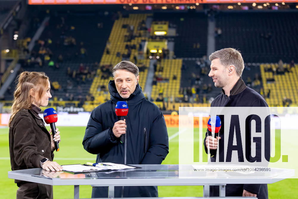 Dortmund, Germany, October 9, 2026, Bundesliga 2026–2027, Matchday 5: Borussia Dortmund vs. SV Werder Bremen. Pictured from left: Nele Ocik, SKY host, and coach Niko Kovac, being interviewed. Kovac (BVB), Thomas Hitzelsperger (SKY expert). DFL and DFB regulations prohibit any use of photographs as image sequences and or quasi-video. Signal Iduna Park, North Rhine-Westphalia