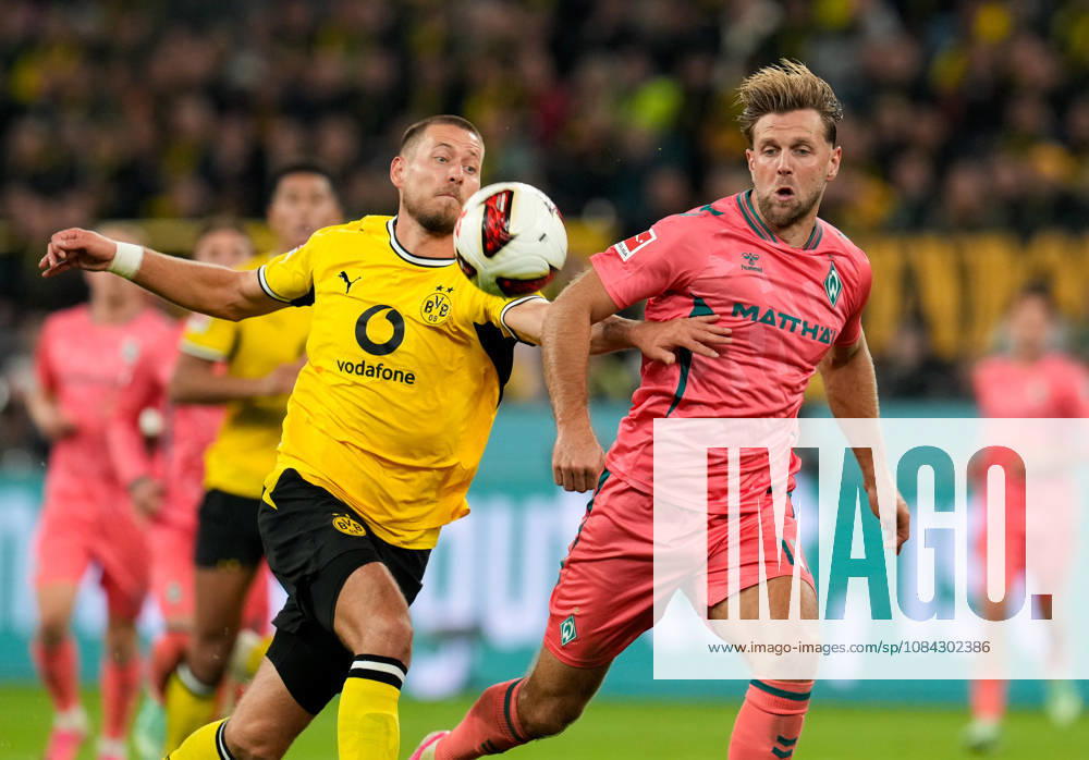 Waldemar Anton of Borussia Dortmund, No. 3, in a tackle with Niclas Fuellkrug of SV Werder Bremen, No. 10 (GER), Borussia Dortmund vs. SV Werder Bremen, Bundesliga, Matchday 5, 2026–27 season, SIGNAL IDUNA PARK, Dortmund, October 9, 2026 DFL regulations prohibit any use of photographs as image sequences and or quasi-video Borussia Dortmund vs. SV Werder Bremen, Bundesliga 1, Matchday 5, 2026–27 season, October 9, 2026, Dortmund