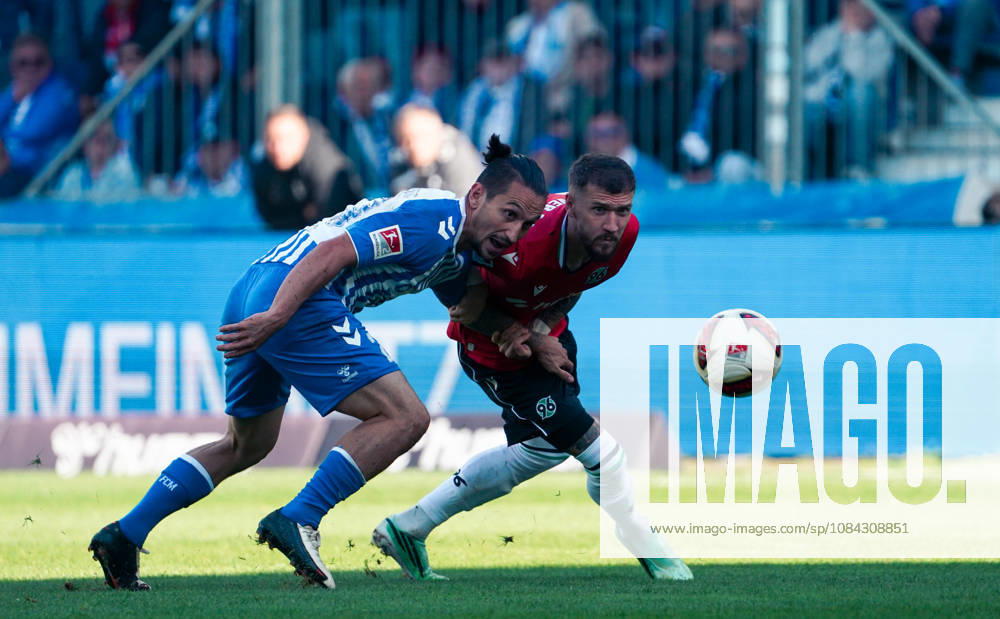 Germany Soccer 2. Bundesliga 2026–2027, Matchday 7: 1. FC Magdeburg vs. Hannover 96 at Avnet Arena, Magdeburg—BarıÅü Atik (1. FC Magdeburg) and Marcel Hartel (Hannover 96) in a tackle. 1. FC Magdeburg, 23; Hannover 96, 10; Avnet Arena, Magdeburg, Lower Saxony, Germany