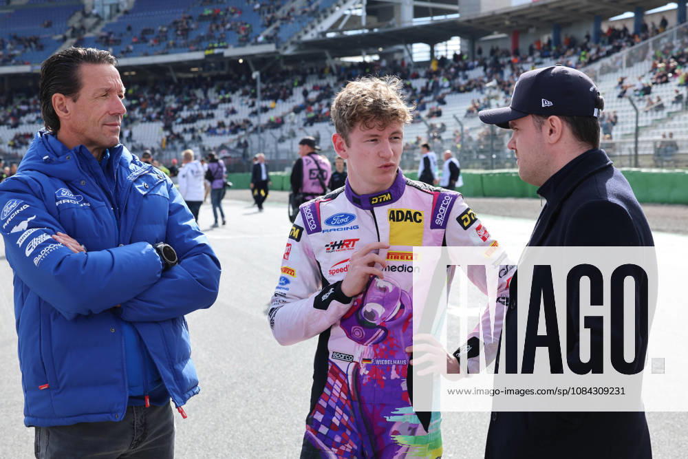 Hockenheim, Germany, October 9–11, 2026; DTM 2026 Season Finale at the Hockenheimring; Saturday, Race 1; Pictured, from left: Manuel Reuter and Finn Wiebelhaus (GER 64) talking with another person; Hockenheimring, Baden-Württemberg