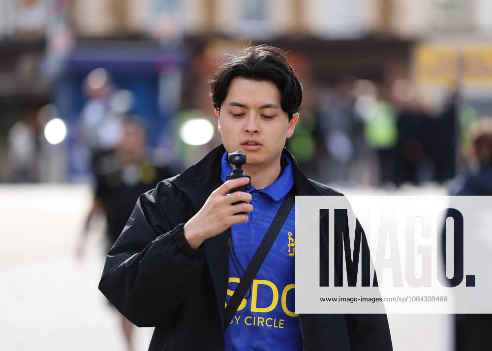 10th October 2026; Stamford Bridge, London, England; Premier League Football, Chelsea versus Bournemouth; A fan wearing a Chelsea home shirt using a DJI Osmo Pocket device to record his arrival at Stamford Bridge for social media JohnxPatrickxFletcher