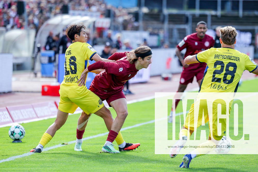 Soccer, SC Fortuna Köln vs. 1 FC Saarbrücken, 3. Liga, Südstation, Matchday 8, 2026–2027 Season Seung Joon Lee of 1. FC Saarbrücken (16) in a tackle against Bennit Bröger of Fortuna Cologne (38). DFB regulations prohibit any use of photographs as image sequences and or quasi-video. North Rhine-Westphalia, Germany