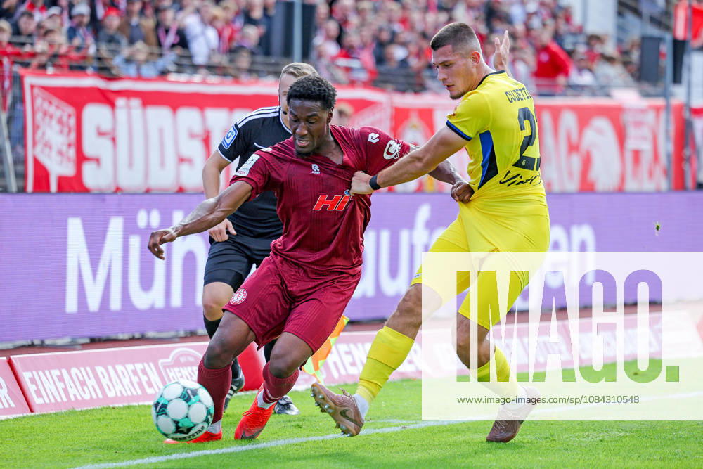 Soccer, SC Fortuna Köln vs. 1 FC Saarbrücken, 3. Liga, Südstation, Matchday 8, 2026–2027 Season Romeo Aigbekaen (Fortuna Cologne) 30 in a tackle against Mladen Cvjetinovic (1. FC Saarbrücken) 21 DFB regulations prohibit any use of photographs as image sequences and or quasi-video North Rhine-Westphalia, Germany