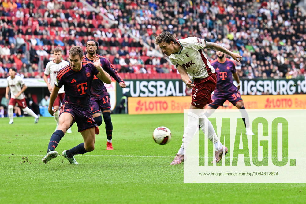 AUGSBURG, GERMANY; 10. OCTOBER: tackle between Josip STANISIC (FC Bayern Munich 44) and Calvin BRACKELMANN (FC Augsburg 2) during the Bundesliga Match between FC Augsburg vs. FC Bayern Munich at Matchday 5 at WWK-Arena DFL REGULATIONS PROHIBIT ANY USE OF PHOTOGRAPHS AS IMAGE SEQUENCES AND OR QUASI-VIDEO