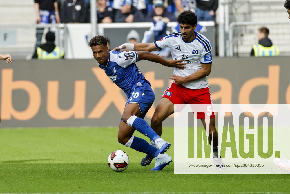 Bambase Conte of TSG Hoffenheim, 20, and Martin Adeline of Hamburger SV, 05, in a tackle, Germany, soccer, Bundesliga 1, Matchday 5, 2026–2027, TSG Hoffenheim vs. Hamburger SV, October 10, 2026, Sinsheim SNP Arena, Germany