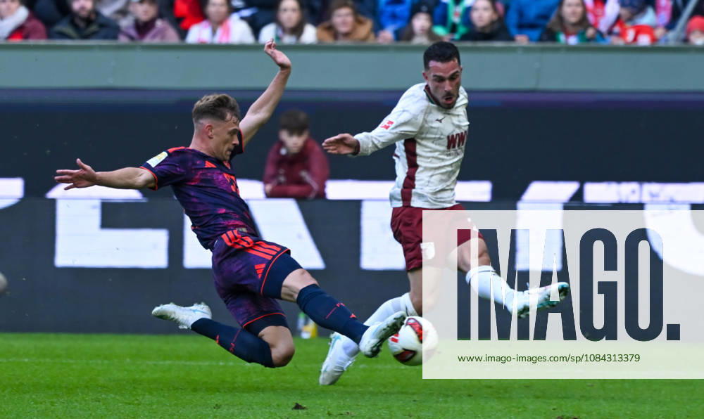 Soccer, Bundesliga 1, FC Augsburg vs. Bayern Munich – Joshua Kimmich (FC Bayern Munich), Arijon Ibrahimovic (FC Augsburg) – tackle, action, battle for the ball. DFL and DFB regulations prohibit any use of photographs as image sequences and or quasi-video. Augsburg