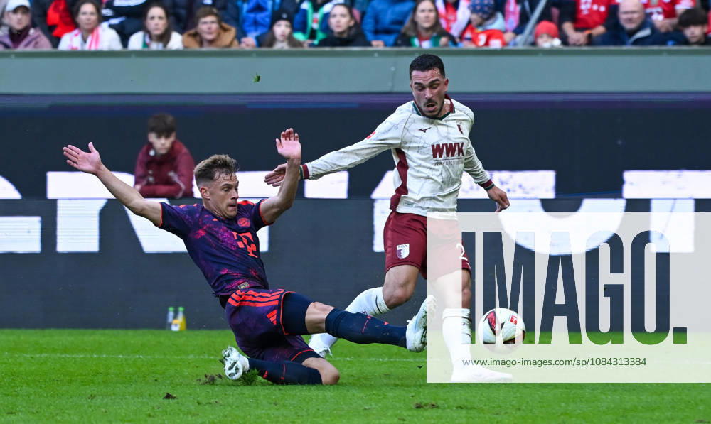 Soccer, Bundesliga 1, FC Augsburg vs. Bayern Munich – Joshua Kimmich (FC Bayern Munich), Arijon Ibrahimovic (FC Augsburg) – tackle, action, battle for the ball. DFL and DFB regulations prohibit any use of photographs as image sequences and or quasi-video. Augsburg