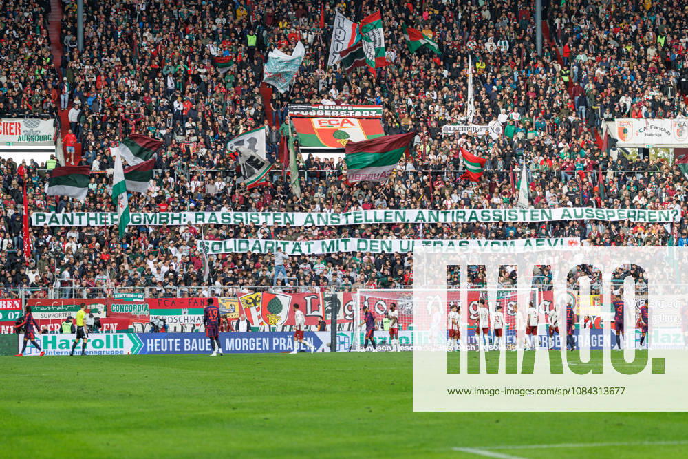 Fans of Team FC Augsburg holding a Solarität banner alongside the AEV Ultras at the match between FC Augsburg and FC Bayern Munich, soccer, men s, Bundesliga, 2026–2027, Matchday 5 on October 10, 2026, in Augsburg, WWK ARENA. DFL and DFB regulations prohibit any use of photographs as image sequences and or quasi-video. Bavaria, Germany