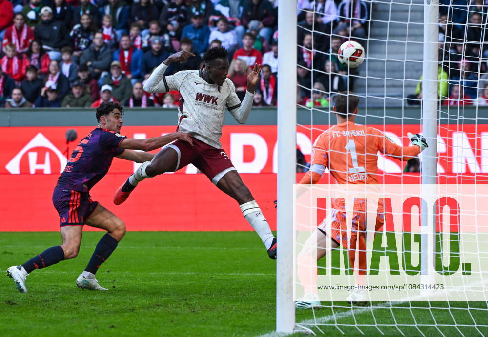 Soccer, Bundesliga 1, FC Augsburg vs. Bayern Munich: Aleksandar Pavlovic (FC Bayern Munich), Juma Bah (FC Augsburg), Manuel Neuer, FC Bayern Munich, tackle, action, battle for the ball. DFL and DFB regulations prohibit any use of photographs as image sequences and or quasi-video. Augsburg