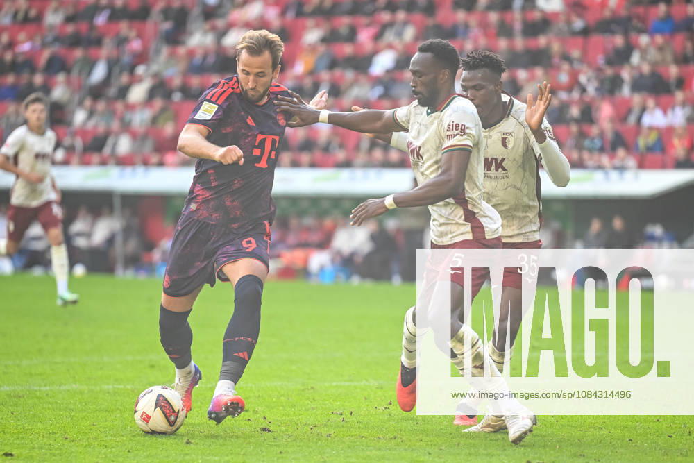Harry Kane of FC Bayern Munich, Chrislain Matsima of FC Augsburg, and Juma Bah of FC Augsburg in a one-on-one battle during the Bundesliga 1 match between FC Augsburg and FC Bayern Munich, at the WWK Arena on October 10, 2026, in Augsburg, Germany. Photo by Harry Langer, DeFodi Images. Harry Kane of FC Bayern Munich, Chrislain Matsima (FC Augsburg) and Juma Bah (FC Augsburg) battle for the ball during the Bundesliga match between FC Augsburg and FC Bayern Munich at WWK Arena on October 10, 2026, in Augsburg, Germany. Photo by Harry Langer, DeFodi Images. DFB and DFL regulations prohibit any use of photographs as image sequences and or quasi-video. Photo by Harry Langer, DeFodi Images. DFB and DFL regulations prohibit any use of photographs as imSEQUENCES AND OR QUASI-VIDEO