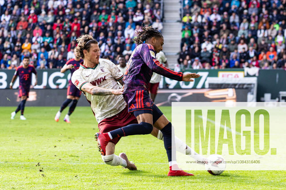 Germany: FC Augsburg vs. FC Bayern Munich, Bundesliga 1, Matchday 5, 2026–27 Season, WWK Arena, Augsburg. Calvin Brackelmann (FC Augsburg, No. 2) in a tackle with Michael Olise (FC Bayern Munich, No. 17). Augsburg, WWK Arena, Bayern, Germany
