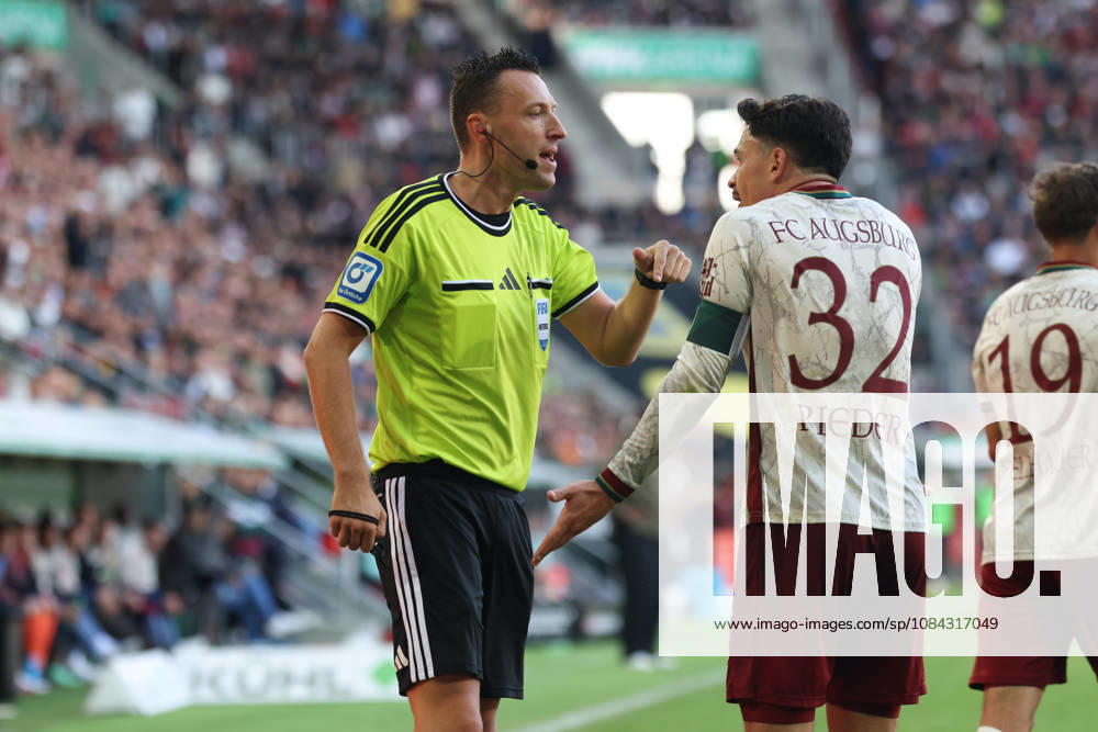 Referee Sven Jablonksi in conversation with Fabian Rieder of FC Augsburg, 32, GER, FC Augsburg vs. FC Bayern Munich, Soccer, Bundesliga, Matchday 5, 2026–2027 Season, October 10, 2026, DFL and DFB regulations prohibit any use of photographs as image sequences and or quasi-video, GER, FC Augsburg vs. FC Bayern Munich, soccer, Bundesliga, Matchday 5, 2026–2027 season, October 10, 2026, Augsburg