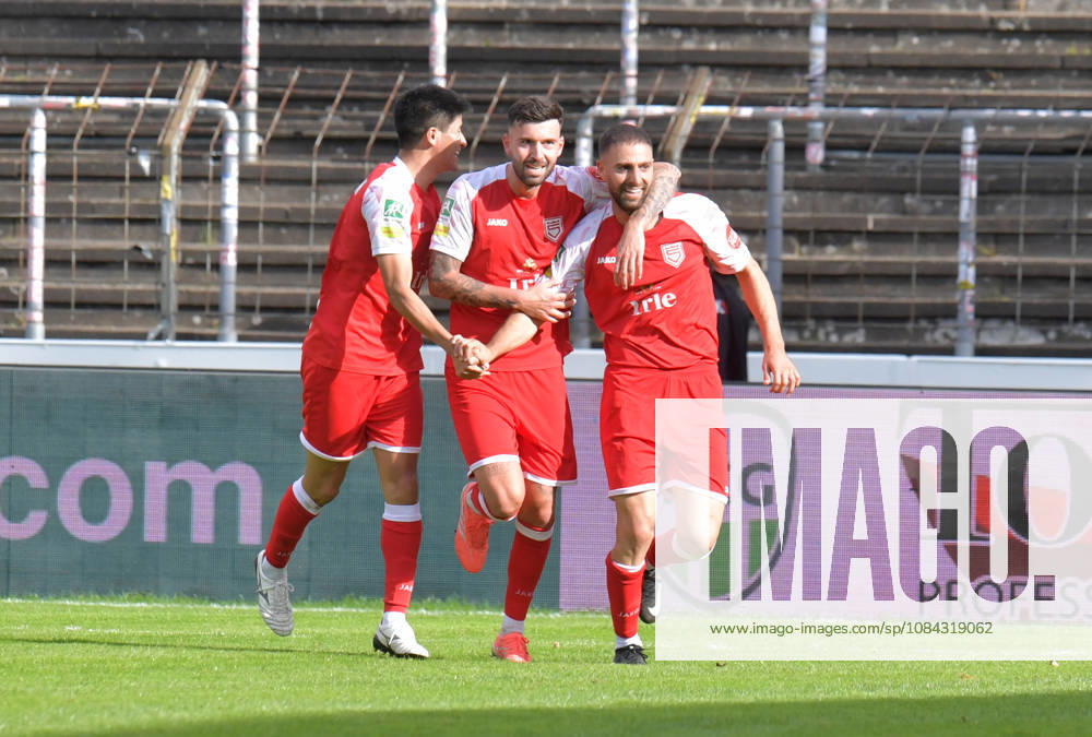 GER, Soccer, Regionalliga West, 2026–2027 Season, Matchday 12, Ohlendorf Stadium in Heidewald, Gütersloh FC vs. SF Siegen 0–5, Goal Celebration by SF Siegen’s Rikuhei Nabesaka, Dennis Brock and goal scorer Serhat Semih Güler, all from SF Siegen, from left, action, single frame, landscape orientation, facial expressions, gestures, celebration, cheering, joy, happiness