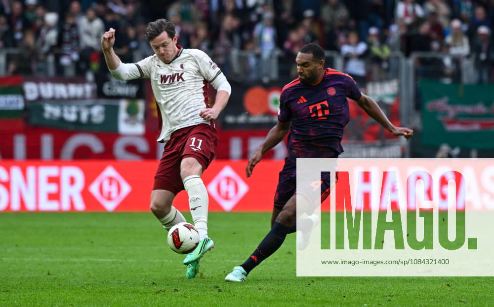 Soccer, Bundesliga 1, FC Augsburg vs. Bayern Munich, Michael Gregoritsch (FC Augsburg), Jonathan Tah, FC Bayern Munich, tackle, action, battle for the ball. DFL and DFB regulations prohibit any use of photographs as image sequences and or quasi-video. Augsburg