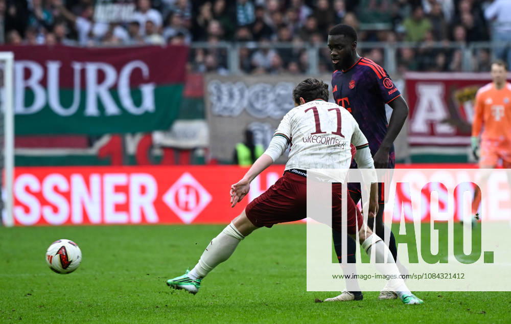 Soccer, Bundesliga 1, FC Augsburg vs. Bayern Munich – Michael Gregoritsch (FC Augsburg), Dayot Upamecano (FC Bayern Munich) – tackle, action, battle for the ball. DFL and DFB regulations prohibit any use of photographs as image sequences and or quasi-video. Augsburg