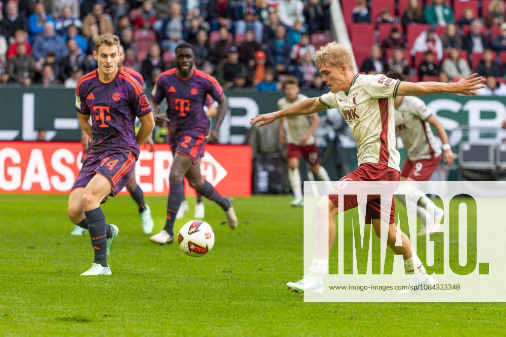Josip Stanisic of FC Bayern Munich and Hennes Behrens of FC Augsburg (left) in a tackle, FC Augsburg vs. FC Bayern Munich, Bundesliga Soccer, Soccer, Bundesliga 1, Matchday 5, October 10, 2026. DFL regulations prohibit any use of photographs as image sequences and or quasi-video.