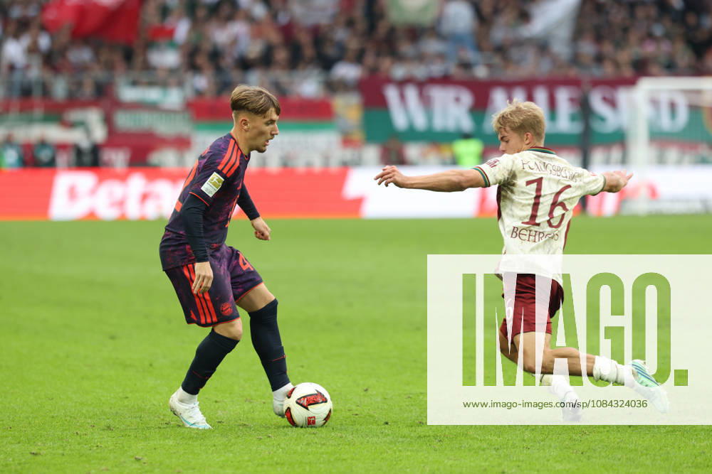 Lennart Karl, FC Bayern Munich, 42, with Hennes Behrens, FC Augsburg, 16, GER, FC Augsburg vs. FC Bayern Munich, Soccer, Bundesliga, Matchday 5, 2026–2027 Season, October 10, 2026, DFL and DFB regulations prohibit any use of photographs as image sequences and or quasi-video, GER, FC Augsburg vs. FC Bayern Munich, soccer, Bundesliga, Matchday 5, 2026–2027 season, October 10, 2026, Augsburg