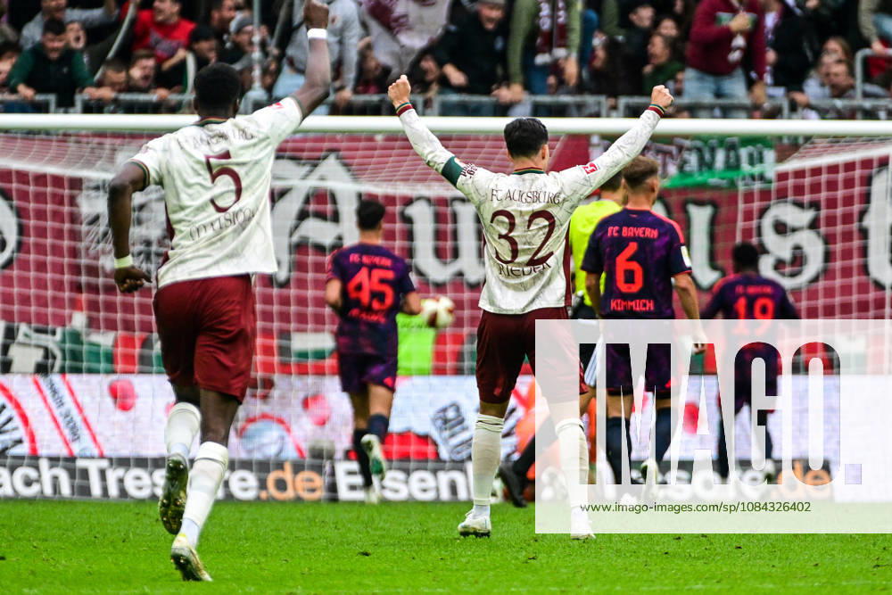 GER, Soccer, Men s, 1st Bundesliga, Matchday 5, FC Augsburg vs. FC Bayern Munich: Augsburg players celebrate after scoring the 2–1 goal; Chrislain Matsima (FC Augsburg, 5), Fabian Rieder (FC Augsburg, 32); Augsburg WWK Arena, Bayern, Germany