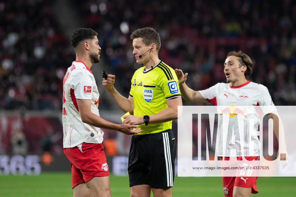 1 German Bundesliga: RB Leipzig vs. Eintracht Frankfurt, October 10, 2026; Referee Daniel Siebert in conversation with Romulo Cardoso da Cruz (40), RB Leipzig; LEIPZIG, GERMANY OCTOBER 10 Bundesliga match between RB Leipzig and Eintracht Frankfurt at the Red Bull Arena on Matchday 5 of the 1. Bundesliga on October 10, 2026 in Leipzig, Germany. DFL regulations prohibit any use of photographs as image sequences and or quasi-video.