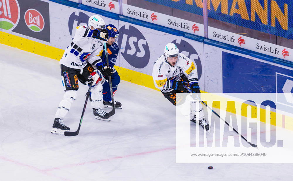 Ice Hockey National League Regular Season: ZSC Lions vs. HC Fribourg, Zurich, Switzerland, Oct. 10, 2026. 5. Simon Seiler (Fribourg) blocks 13. Justin Sigrist (ZSC Lions). 77. Maximilian Streule (Fribourg) with the puck.