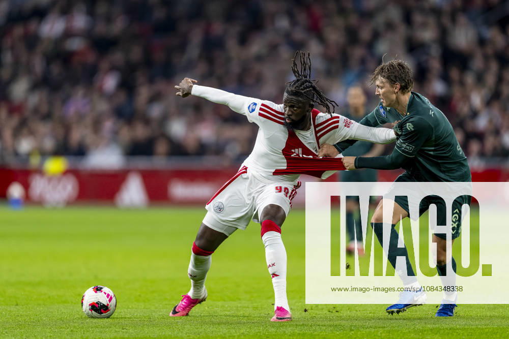 AMSTERDAM l AFC Ajax Amsterdam forward Toluwalase Arokodare and NEC Nijmegen defender Perr Schuurs during the Vriendenloterij Eredivisie match between Ajax and NEC at the Johan Cruijff ArenA on October 10, 2026, in Amsterdam, the Netherlands. Photo by DeFodi Images