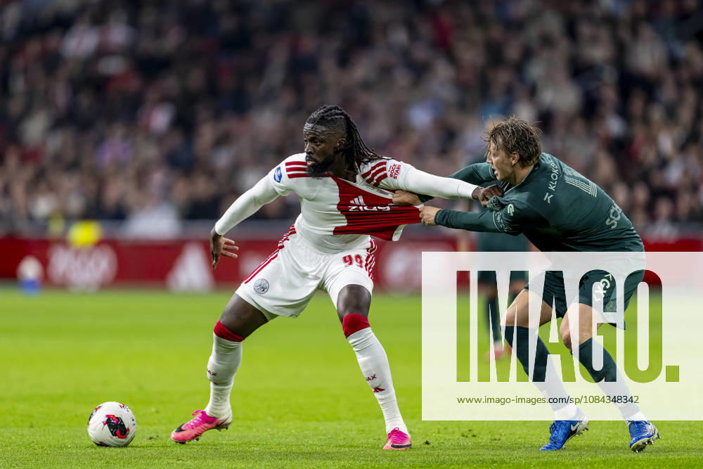 AMSTERDAM l AFC Ajax Amsterdam forward Toluwalase Arokodare and NEC Nijmegen defender Perr Schuurs during the Vriendenloterij Eredivisie match between Ajax and NEC at the Johan Cruijff ArenA on October 10, 2026, in Amsterdam, the Netherlands. Photo by DeFodi Images