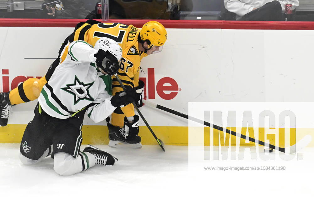 Pittsburgh Penguins right wing Rickard Rakell (67) plays the puck pass Dallas Stars center Justin Hryckowian (49) during the first period at PPG Paints Arena in Pittsburgh on Saturday, October, 10 2026. PIT2026101001 ARCHIExCARPENTER
