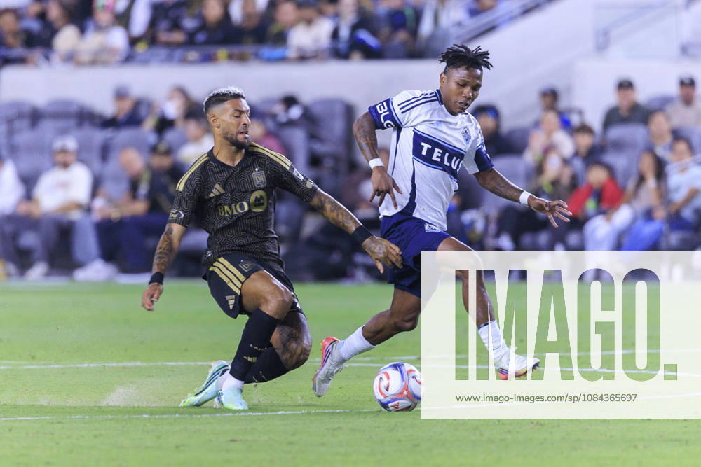 Denis Bouanga 99 of the Los Angeles Football Club falls as he and Edier Ocampo 18 of the Vancouver Whitecaps struggle for possession of the ball during their regular season MLS, Fussball Herren, USA game on Saturday October 10, 2026 at the BMO Stadium in Los Angeles, California. ARIANA RUIZ PI Los Angeles USA - ZUMAp124 20261010_zaa_p124_011