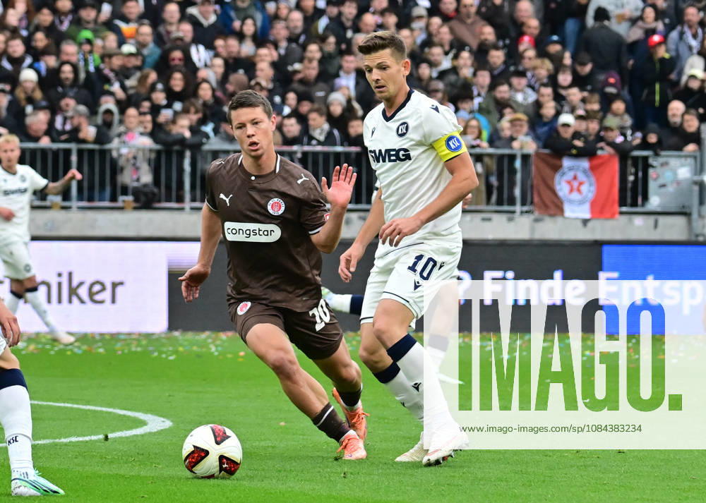 GER Soccer, Men, 2nd Division, Matchday 5, 2026–2027 Season, Hamburg, FC St. Pauli vs. Karlsruher SC: Mathias Rasmussen (Pauli 20) tries to get past Marvin Wanitzek (Karlsruhe 10). DFB and DFL regulations prohibit any use of photographs as image sequences and or quasi-video. Hamburg Millerntorstadion, Hamburg, Germany