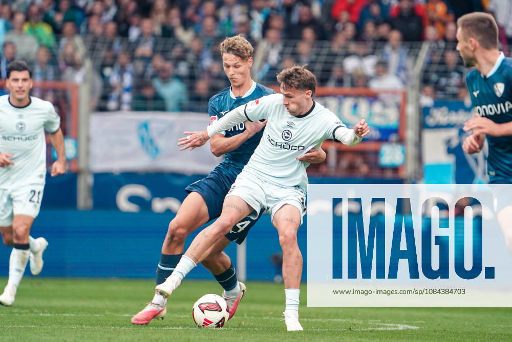 German Soccer 2. Bundesliga 2026–2027, Matchday 7: VfL Bochum vs. Arminia Bielefeld at Vonovia Ruhrstadion in Bochum—Joel Grodowski (Arminia Bielefeld), No. 11, and Tom Meyer (VfL Bochum), No. 34, in a tackle